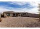Spacious gravel backyard featuring neutral-toned walls and desert landscaping at 18644 N Desert Willow Dr, Maricopa, AZ 85138