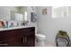 A view of a sink with vanity in a bathroom with a large mirror and a window at 18644 N Desert Willow Dr, Maricopa, AZ 85138
