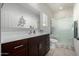 A bathroom featuring a single vanity, a mirror, and a shower with a glass door at 18644 N Desert Willow Dr, Maricopa, AZ 85138
