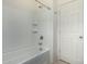 Clean bathroom showcasing a white bathtub with a shower head and tiled wall at 18644 N Desert Willow Dr, Maricopa, AZ 85138