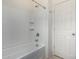 A white bathroom with a tub and shower combination and a wall mounted shower head at 18644 N Desert Willow Dr, Maricopa, AZ 85138