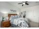 Bright bedroom with neutral décor, a ceiling fan, and view to the en suite bathroom at 18644 N Desert Willow Dr, Maricopa, AZ 85138