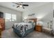 Cozy bedroom featuring a ceiling fan, neutral carpet, and a window for natural light at 18644 N Desert Willow Dr, Maricopa, AZ 85138