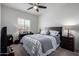 Bright bedroom featuring a ceiling fan, a window, and neutral colored walls at 18644 N Desert Willow Dr, Maricopa, AZ 85138