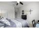 Serene bedroom featuring ample storage, a ceiling fan, and a closet for organized living at 18644 N Desert Willow Dr, Maricopa, AZ 85138