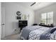 Well lit bedroom with a ceiling fan and window with a view of the outside at 18644 N Desert Willow Dr, Maricopa, AZ 85138