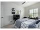 Cozy bedroom with a ceiling fan, a window, and dark wood furniture at 18644 N Desert Willow Dr, Maricopa, AZ 85138