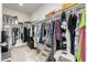 Walk-in closet with ample storage space and multiple hanging rods for organizing clothes at 18644 N Desert Willow Dr, Maricopa, AZ 85138