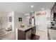 Modern kitchen featuring dark cabinets, stainless appliances, granite countertops, and island seating at 18644 N Desert Willow Dr, Maricopa, AZ 85138