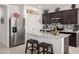 Stylish kitchen featuring stainless steel appliances, granite countertops, and a breakfast bar with barstool seating at 18644 N Desert Willow Dr, Maricopa, AZ 85138