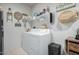Functional laundry room with modern appliances and storage shelves at 18644 N Desert Willow Dr, Maricopa, AZ 85138