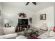 Comfortable living room with a ceiling fan, neutral decor, and a large window at 18644 N Desert Willow Dr, Maricopa, AZ 85138