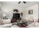 Well decorated living room with white sofas, a glass table and neutral colored walls at 18644 N Desert Willow Dr, Maricopa, AZ 85138