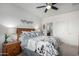 Inviting main bedroom with bedside tables, ceiling fan, and carpeted floors for added comfort at 18644 N Desert Willow Dr, Maricopa, AZ 85138
