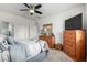 Comfortable main bedroom featuring wooden furniture, a ceiling fan, and a window providing natural light at 18644 N Desert Willow Dr, Maricopa, AZ 85138