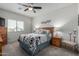 Tranquil main bedroom with soft carpet, complemented by a ceiling fan and a window for natural light at 18644 N Desert Willow Dr, Maricopa, AZ 85138
