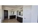 Bathroom features dual vanities, dark cabinetry, modern lighting, and separate toilet area at 19201 W Missouri Ave, Litchfield Park, AZ 85340