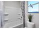 Bright bathroom with a shower-tub combination, neutral tile and patriotic view at 19201 W Missouri Ave, Litchfield Park, AZ 85340