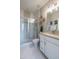 Modern bathroom with glass-enclosed shower, white vanity, and stylish tile accents at 19201 W Missouri Ave, Litchfield Park, AZ 85340