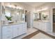 Bright bathroom with double vanity, walk-in shower, and neutral finishes, creating a spa-like experience at 19201 W Missouri Ave, Litchfield Park, AZ 85340