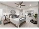 Bright bedroom with ceiling fan, stylish decor and view to bathroom at 19201 W Missouri Ave, Litchfield Park, AZ 85340