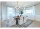 Elegant dining room with chandelier, large windows, and stylish decor at 19201 W Missouri Ave, Litchfield Park, AZ 85340