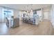 Modern kitchen with a center island, white cabinets, and stylish lighting fixtures at 19201 W Missouri Ave, Litchfield Park, AZ 85340