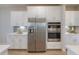 Close up of kitchen with stainless steel refrigerator and built-in oven appliances at 19201 W Missouri Ave, Litchfield Park, AZ 85340