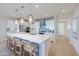 Bright kitchen with stainless steel appliances, large island, and stylish pendant lighting at 19201 W Missouri Ave, Litchfield Park, AZ 85340