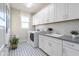Well-organized laundry room featuring modern appliances, ample storage, and stylish flooring at 19201 W Missouri Ave, Litchfield Park, AZ 85340