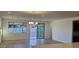 Bright living room with backyard views, a sliding glass door, and modern lighting at 19201 W Missouri Ave, Litchfield Park, AZ 85340