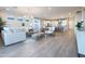 Open concept living area with wood floors, neutral decor, and lots of natural light at 19201 W Missouri Ave, Litchfield Park, AZ 85340