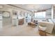 Bright living room with striped walls, stylish chandelier, comfortable seating, and a built-in desk area at 19201 W Missouri Ave, Litchfield Park, AZ 85340