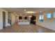 Open-concept living area featuring modern chandelier lighting, wood-look tile flooring, and neutral paint at 19201 W Missouri Ave, Litchfield Park, AZ 85340