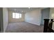 Spacious loft area featuring carpeted floors, recessed lighting, and a large window for natural light at 19201 W Missouri Ave, Litchfield Park, AZ 85340
