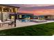 Beautiful backyard with covered patios, a grill, outdoor seating, a swimming pool and spa, and manicured landscaping at 19912 E Natalie Way, Queen Creek, AZ 85142