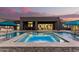 Beautiful backyard has a sparkling pool and spa, a covered patio, and manicured landscaping with an outdoor grill at 19912 E Natalie Way, Queen Creek, AZ 85142