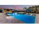 This expansive backyard boasts a refreshing swimming pool, jacuzzi, and manicured landscaping with outdoor features at 19912 E Natalie Way, Queen Creek, AZ 85142