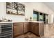 Modern bar area with custom cabinets, wine cooler, and beverage center at 19912 E Natalie Way, Queen Creek, AZ 85142