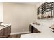 Stylish bar area featuring a wine rack, mini-fridge, and quartz countertops at 19912 E Natalie Way, Queen Creek, AZ 85142