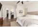 Bright main bedroom featuring a bed with a tufted headboard, and walk-in closet at 19912 E Natalie Way, Queen Creek, AZ 85142
