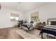 Bright bedroom featuring two iron beds, natural light, and a dedicated gaming area with a modern desk at 19912 E Natalie Way, Queen Creek, AZ 85142