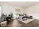 Spacious bedroom featuring two beds, a work desk, and wood look tile flooring at 19912 E Natalie Way, Queen Creek, AZ 85142