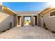 Open-air courtyard featuring tiled flooring and modern architecture, leading to lush landscaping views at 19912 E Natalie Way, Queen Creek, AZ 85142