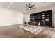 Open-concept dining room with built-in shelves, a modern table set, and wood flooring at 19912 E Natalie Way, Queen Creek, AZ 85142