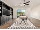 Bright dining room featuring a wooden table, sleek chairs, and stylish built-in shelving at 19912 E Natalie Way, Queen Creek, AZ 85142