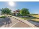 Exterior view of community building showing landscaping, covered entrance, and ample parking at 19912 E Natalie Way, Queen Creek, AZ 85142