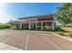 Exterior daytime view of the community clubhouse featuring modern design and ample parking at 19912 E Natalie Way, Queen Creek, AZ 85142