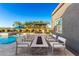 Modern firepit area with seating around the in-ground pool at 19912 E Natalie Way, Queen Creek, AZ 85142