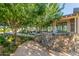 A stone fountain flows near the community center, surrounded by lush landscaping and mature trees at 19912 E Natalie Way, Queen Creek, AZ 85142